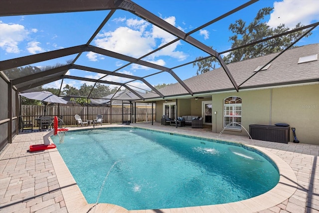 view of swimming pool with ceiling fan, outdoor lounge area, a patio area, and a fenced in pool
