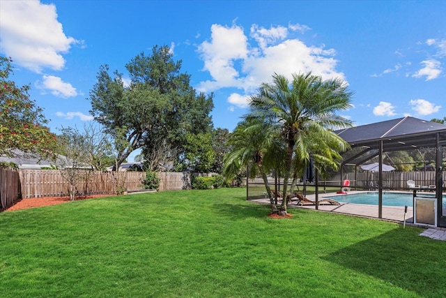 view of yard featuring a fenced in pool, a lanai, a fenced backyard, and a patio area