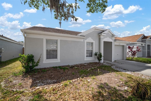 single story home featuring stucco siding, driveway, and a garage