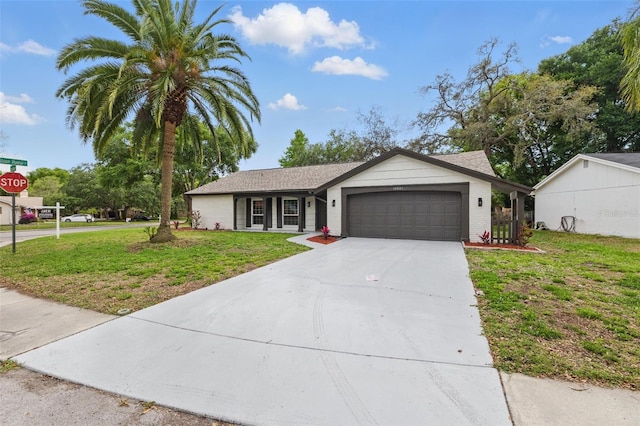 12601 Stone House Loop, Hudson, FL 34667 - ranch-style home featuring an attached garage, concrete driveway, and a front lawn