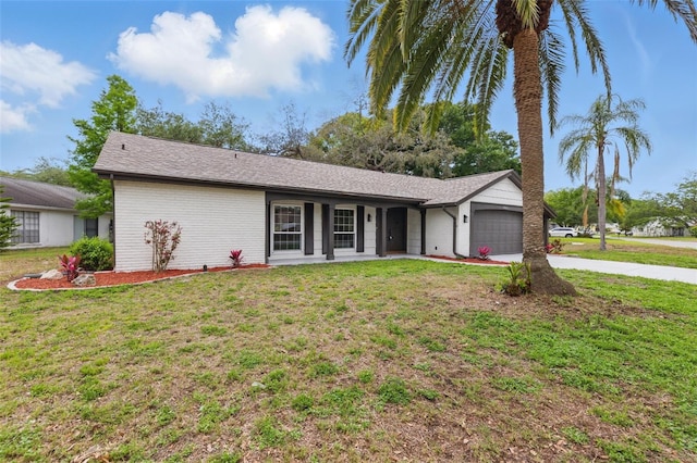12601 Stone House Loop, Hudson, FL 34667 - ranch-style home featuring concrete driveway, a front lawn, and a garage