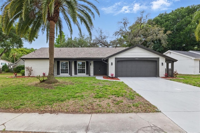 12601 Stone House Loop, Hudson, FL 34667 - ranch-style house with brick siding, a garage, a front yard, and concrete driveway