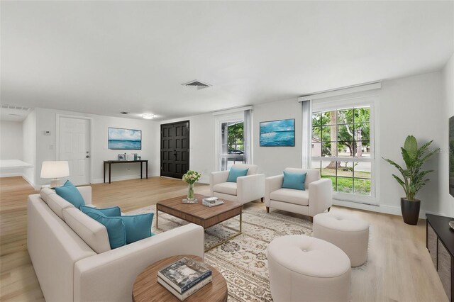 12601 Stone House Loop, Hudson, FL 34667 - living area with visible vents, baseboards, and wood finished floors