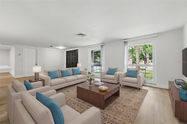 12601 Stone House Loop, Hudson, FL 34667 - living room featuring visible vents, light wood finished floors, and baseboards