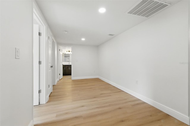 12601 Stone House Loop, Hudson, FL 34667 - hallway with recessed lighting, baseboards, visible vents, and light wood-style flooring