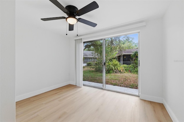 12601 Stone House Loop, Hudson, FL 34667 - spare room with baseboards, a ceiling fan, and wood finished floors
