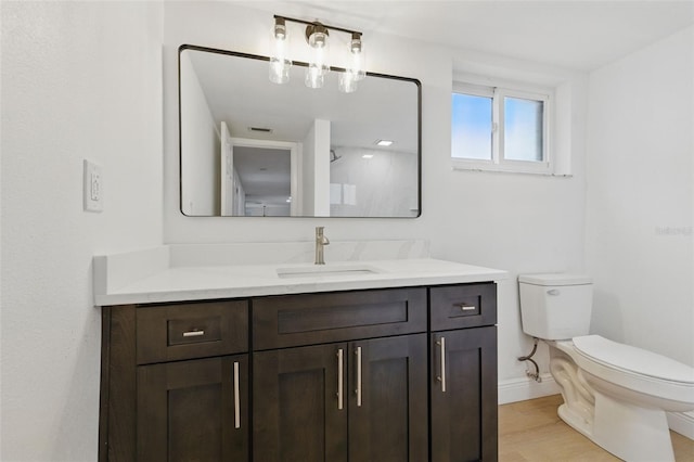 12601 Stone House Loop, Hudson, FL 34667 - bathroom with vanity, baseboards, wood finished floors, and toilet