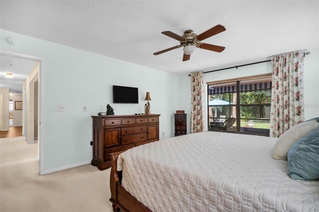 bedroom with a ceiling fan, baseboards, and light colored carpet