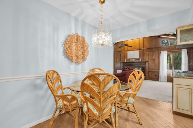 dining room featuring ceiling fan with notable chandelier and light wood-type flooring