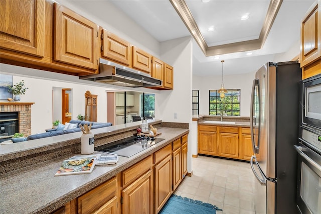 10 Greenhaven Cir, Oldsmar, FL 34677 - kitchen featuring freestanding refrigerator, under cabinet range hood, black electric stovetop, a tray ceiling, and wall oven