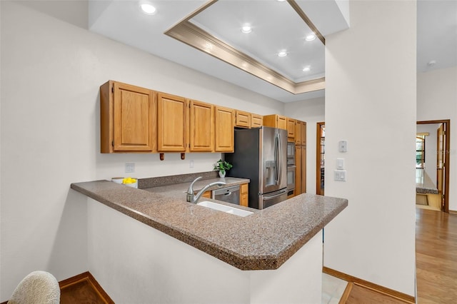 10 Greenhaven Cir, Oldsmar, FL 34677 - kitchen featuring stainless steel appliances, a raised ceiling, a sink, baseboards, and ornamental molding