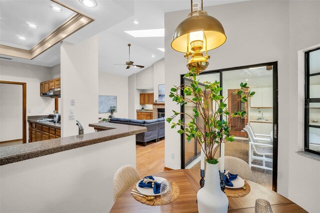 10 Greenhaven Cir, Oldsmar, FL 34677 - dining space featuring a skylight, a ceiling fan, recessed lighting, light wood-style floors, and lofted ceiling