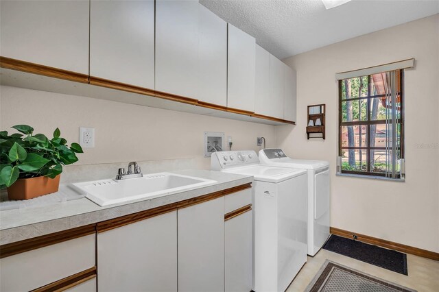 10 Greenhaven Cir, Oldsmar, FL 34677 - laundry room featuring cabinet space, washing machine and dryer, baseboards, and a textured ceiling