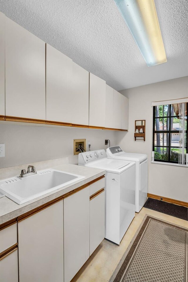 10 Greenhaven Cir, Oldsmar, FL 34677 - laundry area with cabinet space, a textured ceiling, and washing machine and dryer