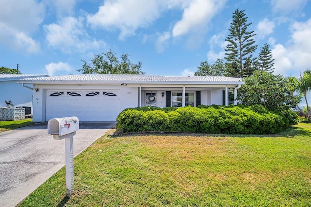 ranch-style house with concrete driveway, stucco siding, a garage, a front yard, and metal roof
