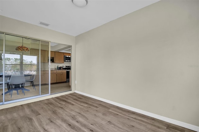 living room featuring light wood-type flooring and baseboards