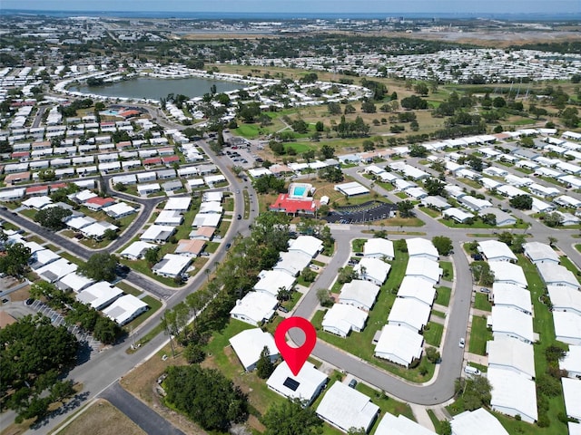 aerial view of property's location featuring a large body of water and nearby suburban area