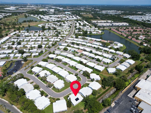 aerial view of property's location with a nearby body of water and nearby suburban area