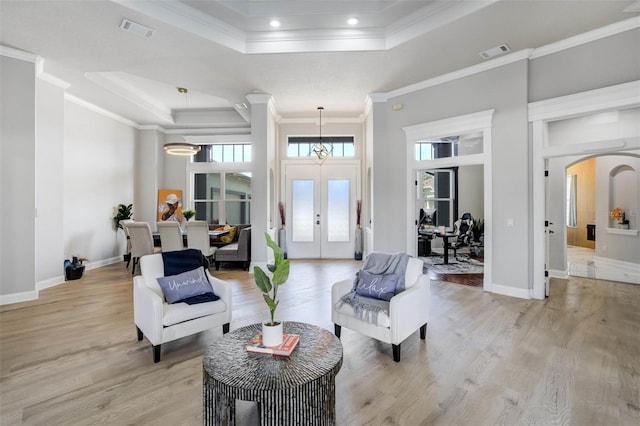 655 Whisper Woods Dr, Lakeland, FL 33813 - interior space featuring visible vents, a raised ceiling, crown molding, and light wood finished floors