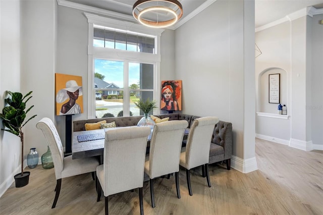 655 Whisper Woods Dr, Lakeland, FL 33813 - dining space with wood finished floors, crown molding, and a towering ceiling