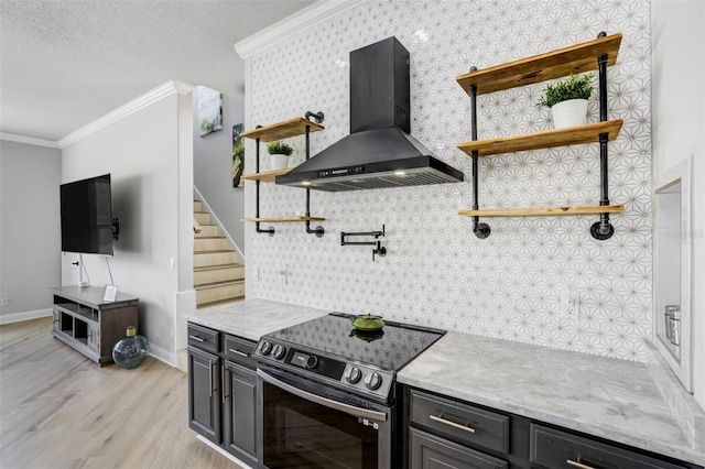 655 Whisper Woods Dr, Lakeland, FL 33813 - kitchen with light wood-style floors, open shelves, wall chimney range hood, ornamental molding, and stainless steel electric stove