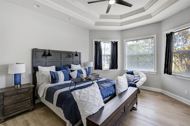 655 Whisper Woods Dr, Lakeland, FL 33813 - bedroom featuring ornamental molding, wood finished floors, multiple windows, and a tray ceiling