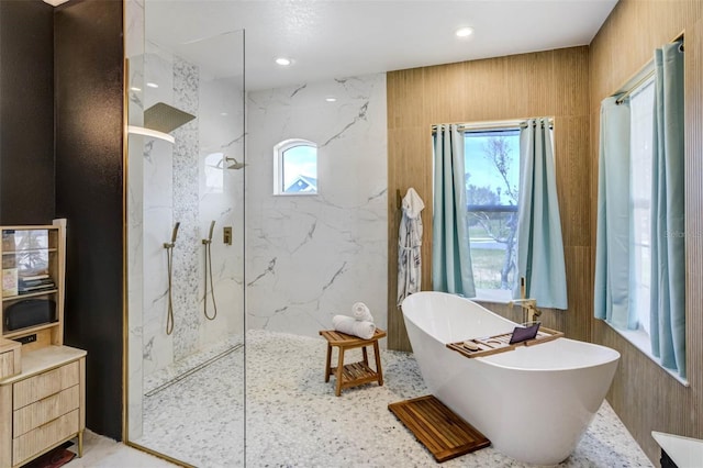 655 Whisper Woods Dr, Lakeland, FL 33813 - full bathroom featuring recessed lighting, a marble finish shower, a freestanding tub, and plenty of natural light