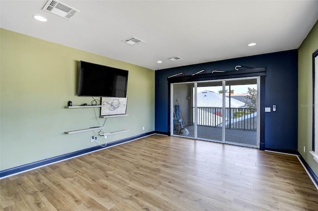 655 Whisper Woods Dr, Lakeland, FL 33813 - unfurnished living room with baseboards, visible vents, and wood finished floors