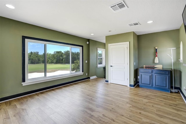 655 Whisper Woods Dr, Lakeland, FL 33813 - unfurnished living room with baseboards, visible vents, light wood-style floors, and recessed lighting