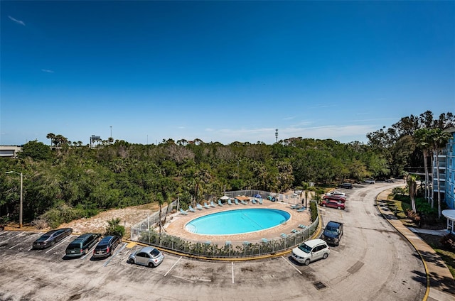 pool featuring a wooded view