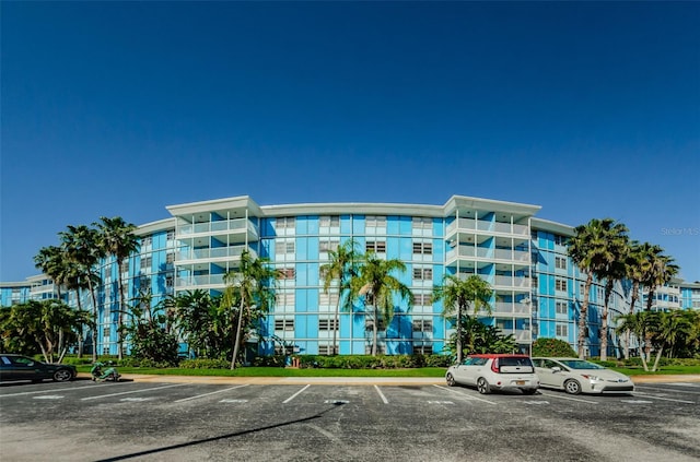view of building exterior featuring uncovered parking