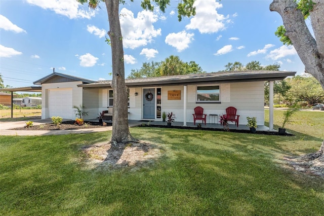 7494 7th St N, Saint Petersburg, FL 33702 - ranch-style house featuring covered porch, driveway, a front yard, and a garage
