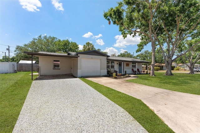 7494 7th St N, Saint Petersburg, FL 33702 - ranch-style house with a garage, a front lawn, fence, gravel driveway, and an attached carport