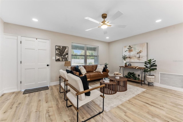 7494 7th St N, Saint Petersburg, FL 33702 - living room featuring visible vents, a ceiling fan, light wood-style floors, and baseboards
