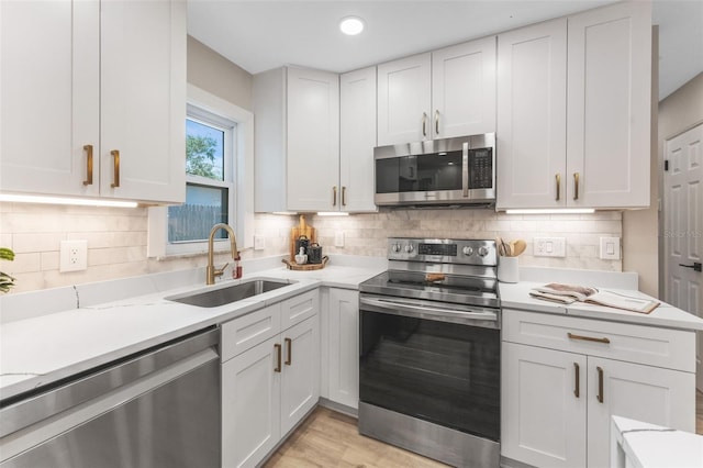 7494 7th St N, Saint Petersburg, FL 33702 - kitchen with light countertops, appliances with stainless steel finishes, a sink, and tasteful backsplash