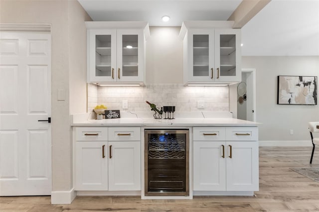 7494 7th St N, Saint Petersburg, FL 33702 - bar with wine cooler, baseboards, decorative backsplash, and light wood-type flooring