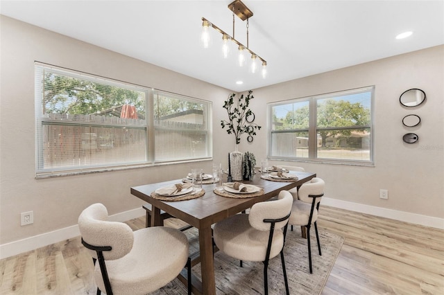 7494 7th St N, Saint Petersburg, FL 33702 - dining area featuring plenty of natural light, baseboards, and light wood-style floors