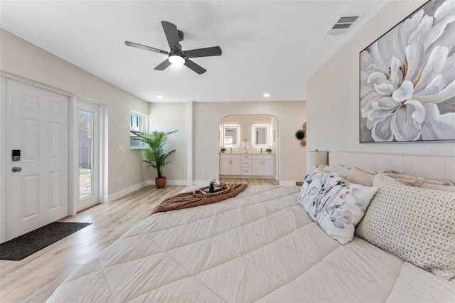 7494 7th St N, Saint Petersburg, FL 33702 - bedroom featuring access to exterior, visible vents, arched walkways, baseboards, and light wood finished floors