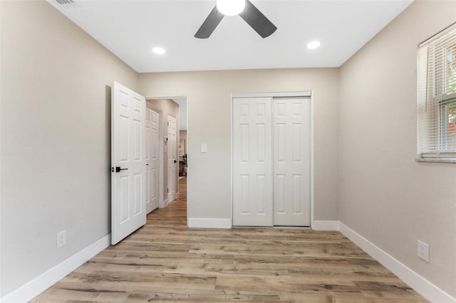 7494 7th St N, Saint Petersburg, FL 33702 - unfurnished bedroom with baseboards, ceiling fan, wood finished floors, and a closet