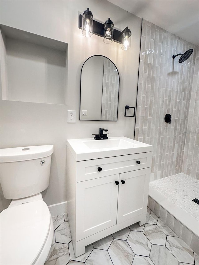 7494 7th St N, Saint Petersburg, FL 33702 - full bath with vanity, marble finish floor, toilet, baseboards, and a tile shower