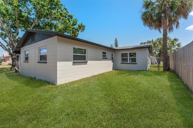7494 7th St N, Saint Petersburg, FL 33702 - rear view of house featuring a lawn and fence