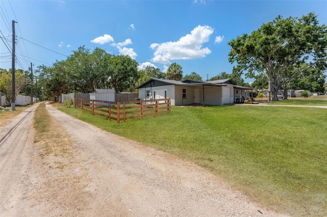 7494 7th St N, Saint Petersburg, FL 33702 - view of front of home with fence, dirt driveway, and a front yard