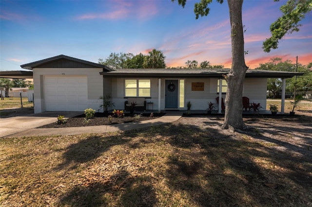 7494 7th St N, Saint Petersburg, FL 33702 - ranch-style home featuring a porch, an attached garage, driveway, and a carport