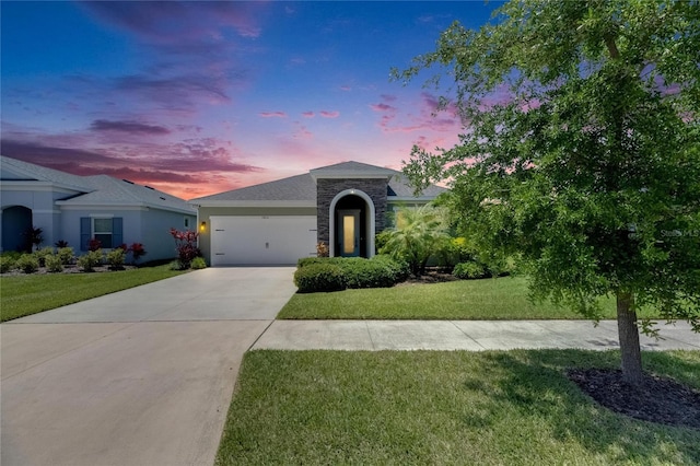 5814 Silver Sun Dr, Apollo Beach, FL 33572 - ranch-style house with concrete driveway, stone siding, a lawn, and an attached garage