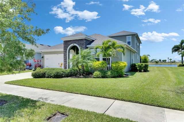 5814 Silver Sun Dr, Apollo Beach, FL 33572 - view of front of property with a front yard, a water view, and stucco siding