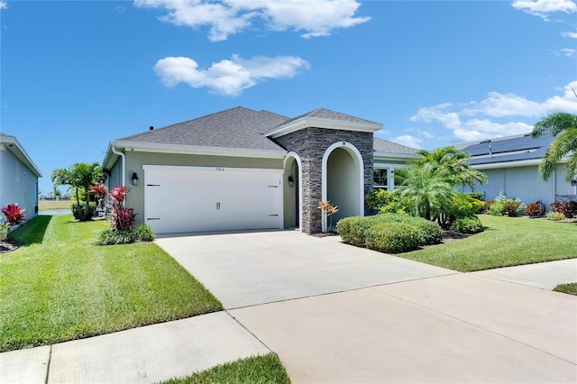 5814 Silver Sun Dr, Apollo Beach, FL 33572 - ranch-style home featuring a garage, stone siding, a front lawn, and driveway