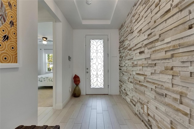 5814 Silver Sun Dr, Apollo Beach, FL 33572 - entrance foyer with light wood-style floors, ceiling fan, baseboards, and a tray ceiling