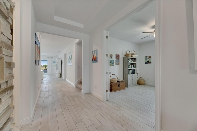 5814 Silver Sun Dr, Apollo Beach, FL 33572 - hallway featuring stairs, light wood-style floors, and baseboards