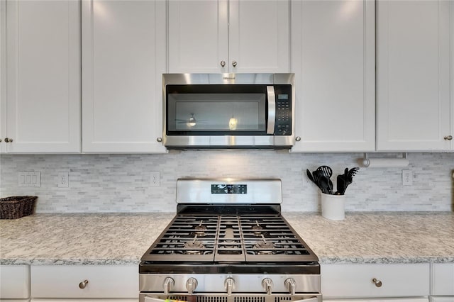 5814 Silver Sun Dr, Apollo Beach, FL 33572 - kitchen featuring stainless steel appliances, light countertops, and white cabinets