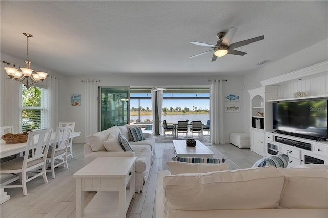 5814 Silver Sun Dr, Apollo Beach, FL 33572 - living area with a chandelier, plenty of natural light, and light wood-type flooring